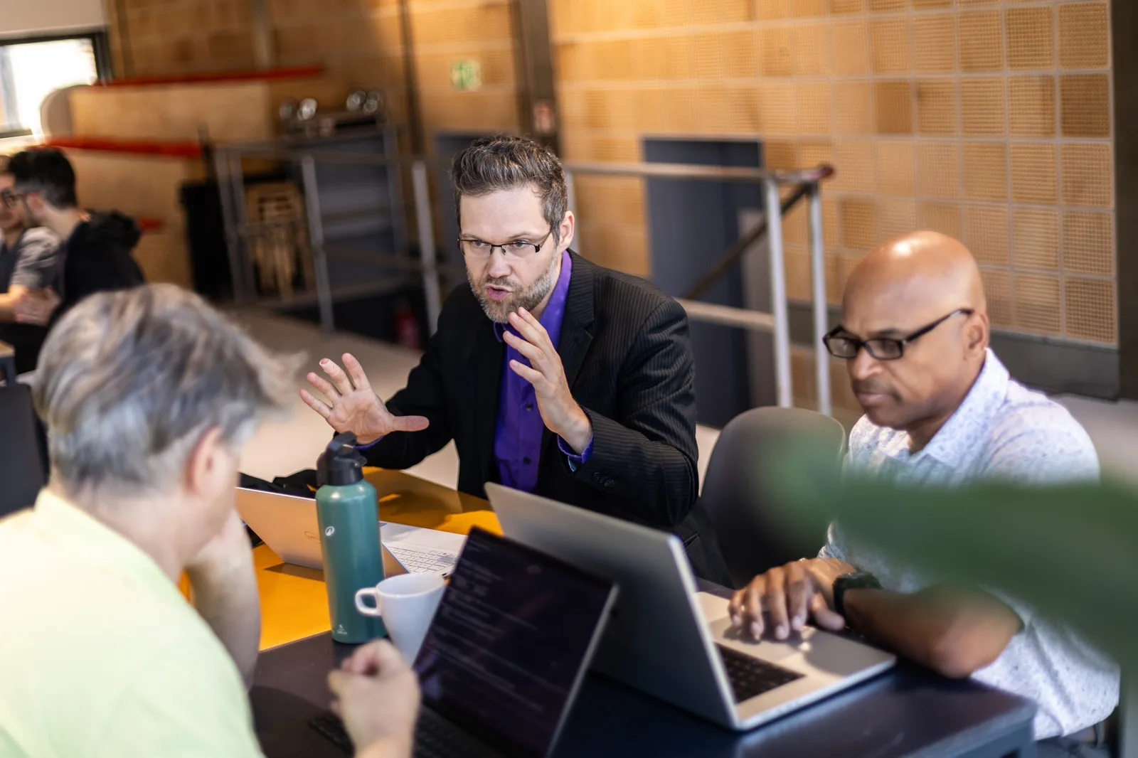 Mark coaching two builders mid hackathon