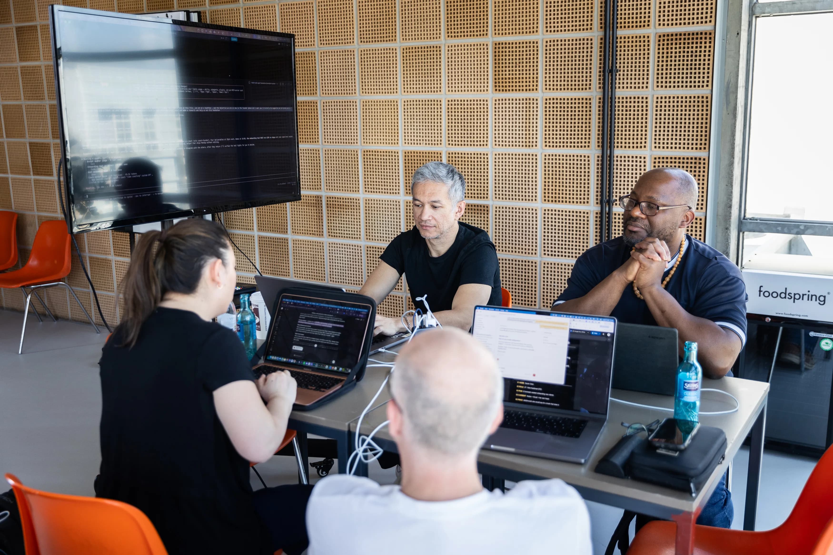 Small team around laptops and a shared screen